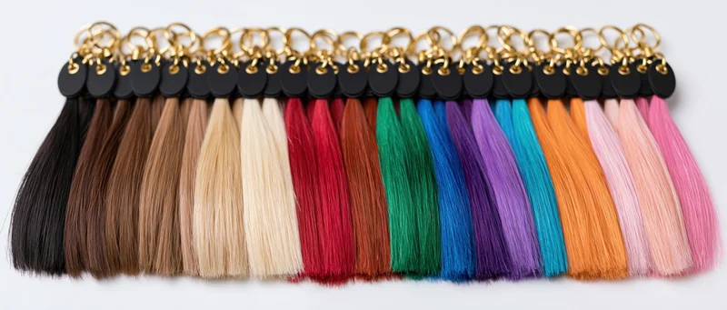 Professional hair extension color swatch chart laid flat on white background