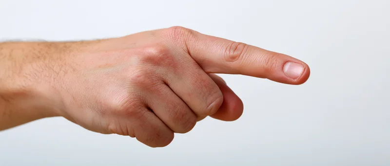Male hand pointing with index finger against white background