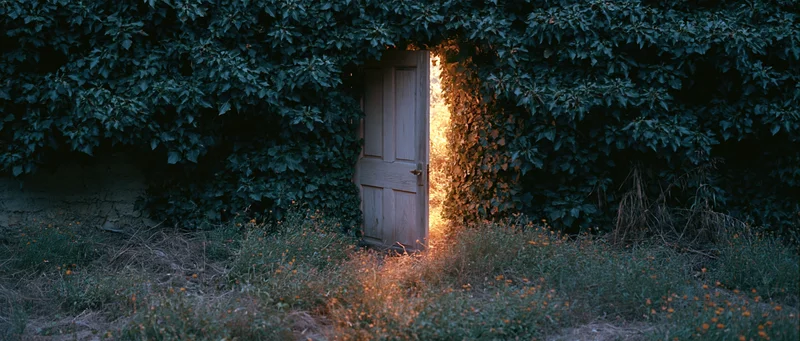 Weathered wooden door slightly ajar in dense ivy-covered wall, light glowing from within, overgrown garden setting