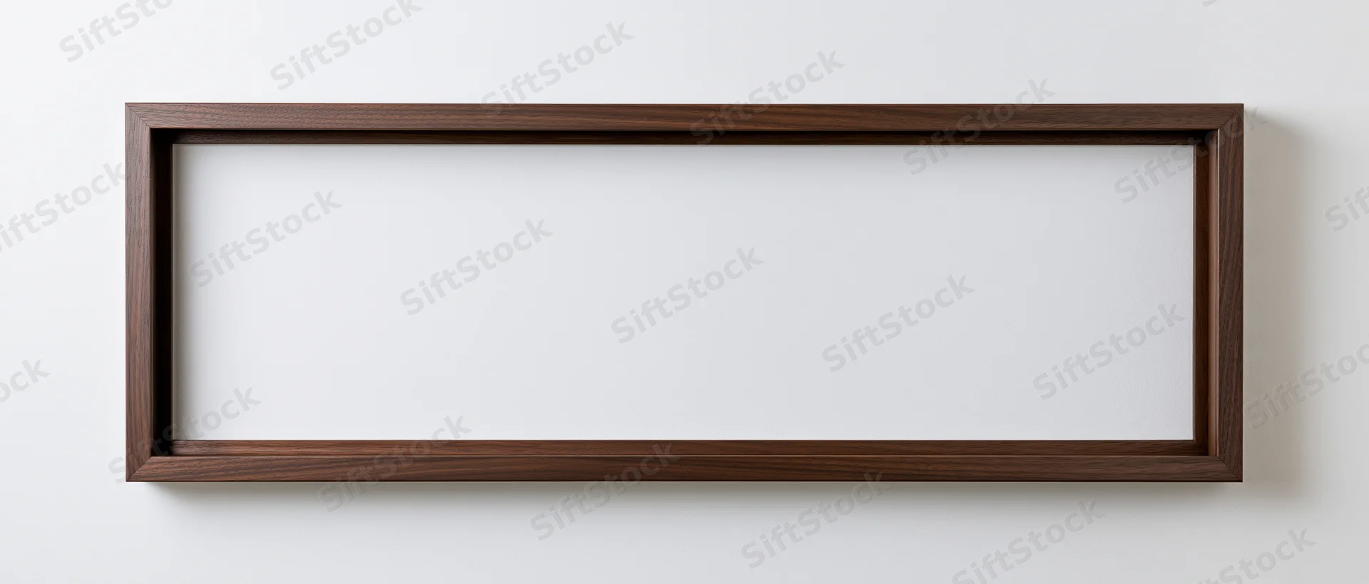 Wide rectangular wooden frame hanging on white wall with empty white interior