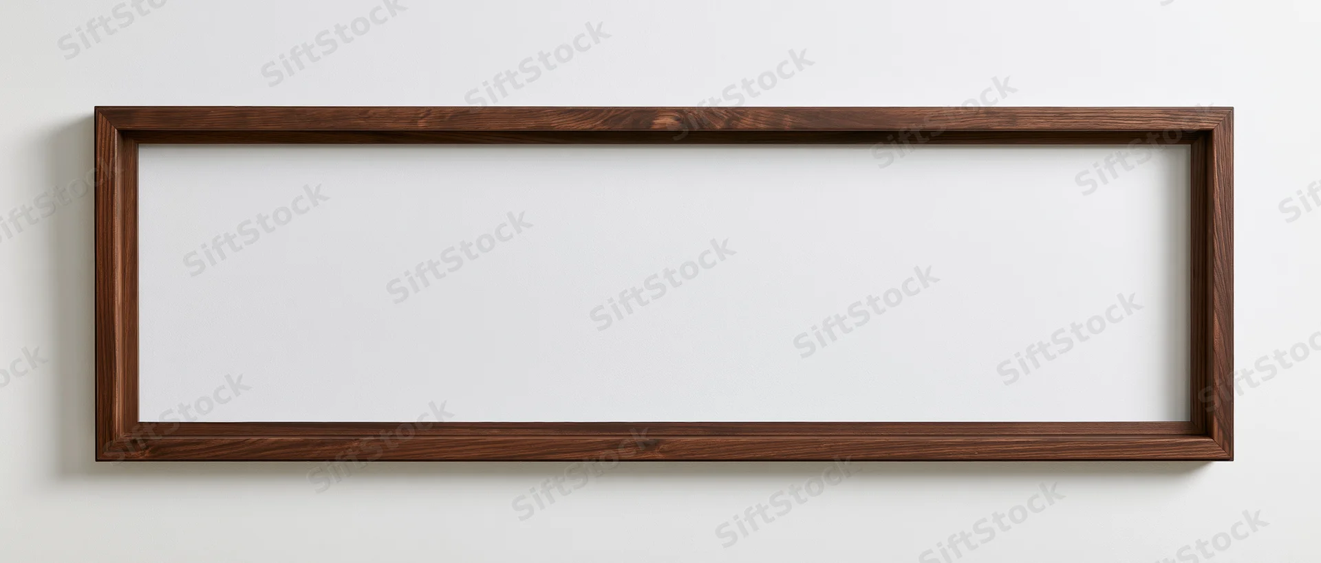 Wide rectangular wooden frame hanging on a white wall with empty white interior