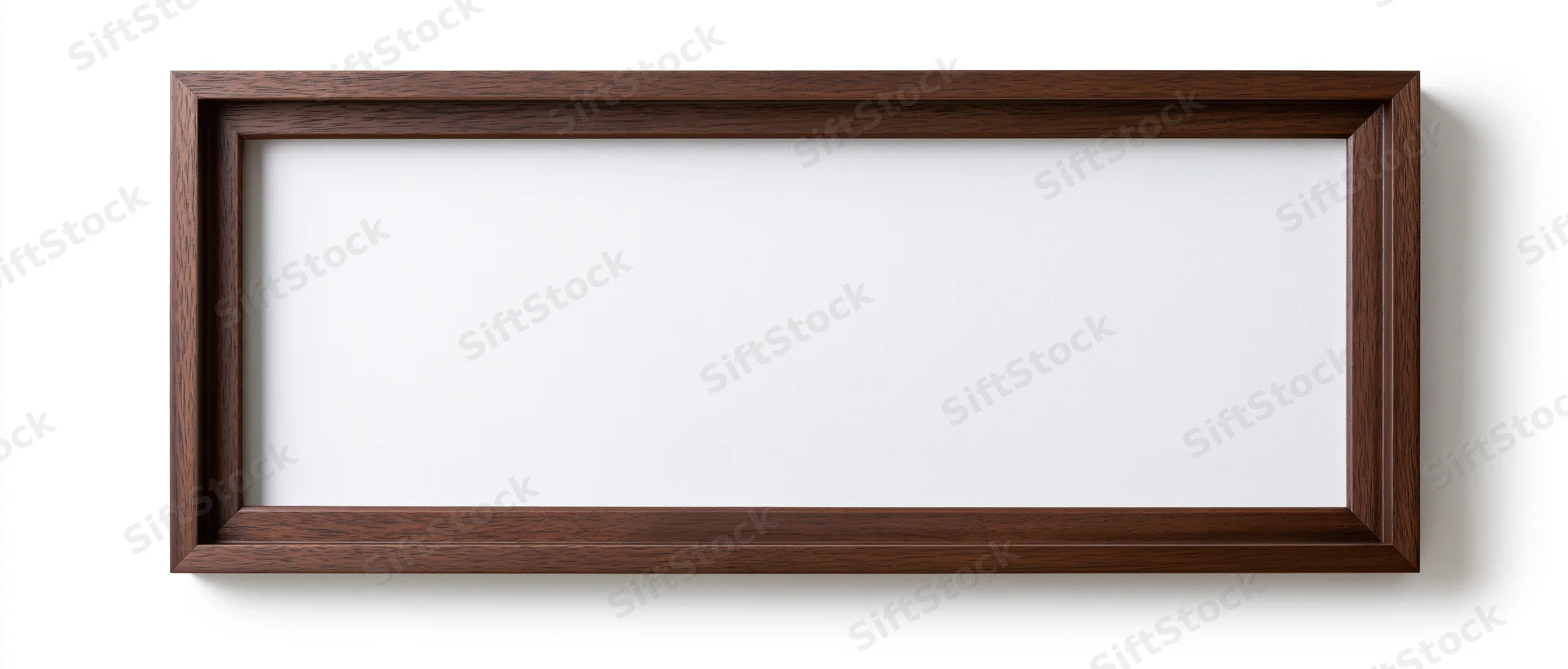 Wide rectangular wooden picture frame with empty white interior hanging on white wall
