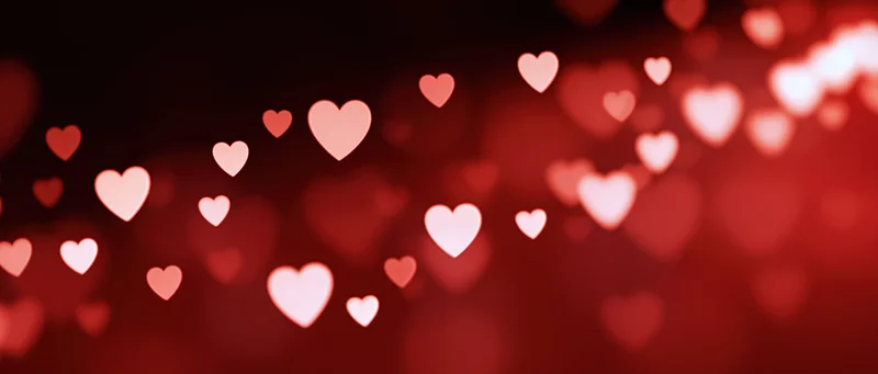 Glowing hearts in soft red bokeh background for valentines day
