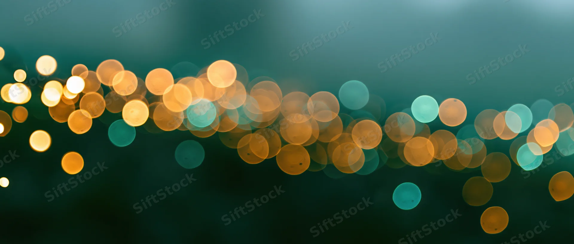 Abstract bokeh lights in warm and cool tones against a dark background