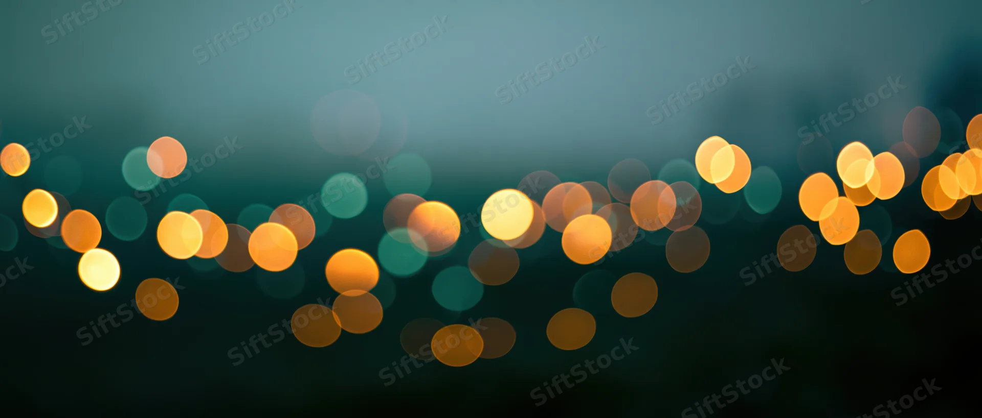 Blurred circular lights in warm tones against a dark teal background