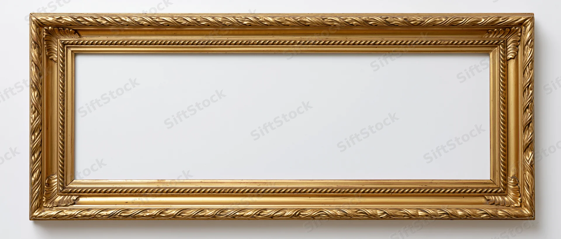 Ornate gold picture frame with intricate detailing mounted on white wall