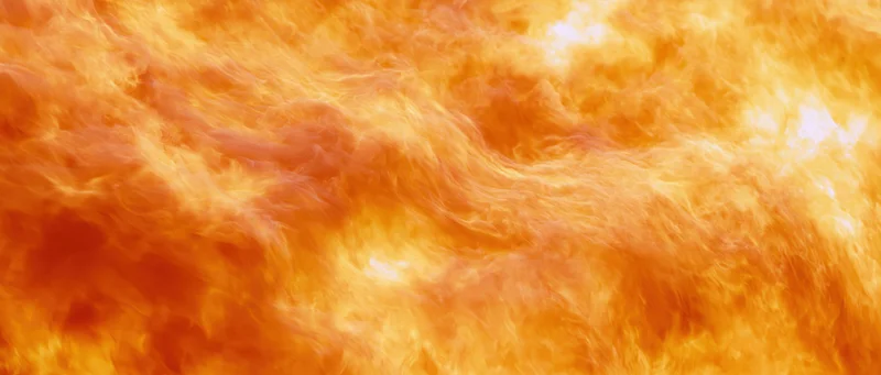 Close-up abstract texture of roaring flames filling the entire frame