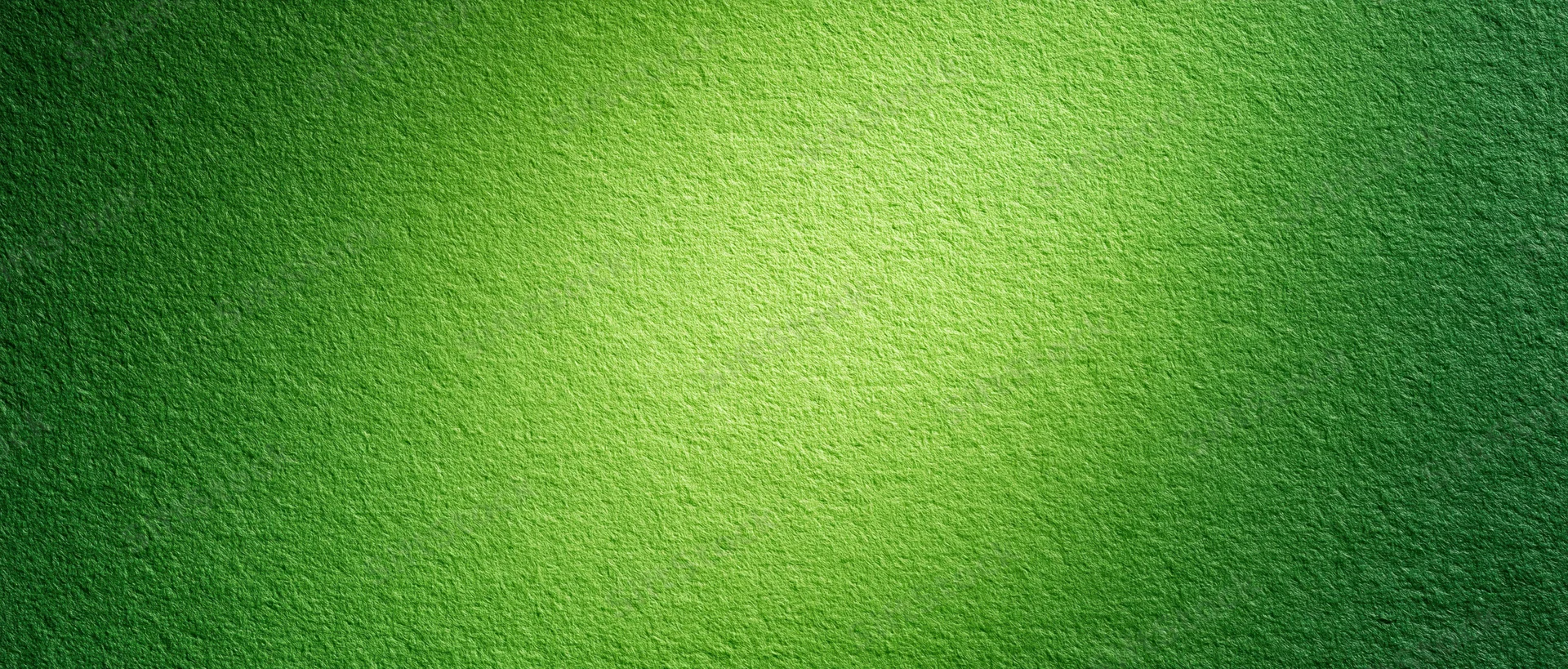 Close-up of green painted textured paper surface with gradient lighting and soft shadows