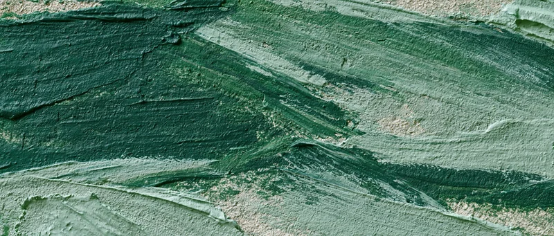 Close-up of rough green-painted concrete wall surface with visible brushstrokes and texture
