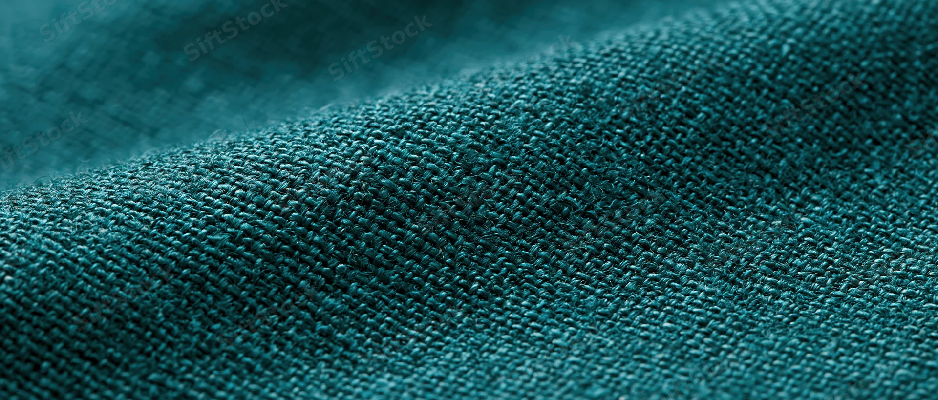 Close-up of dark forest green linen fabric showing woven texture and natural weave pattern