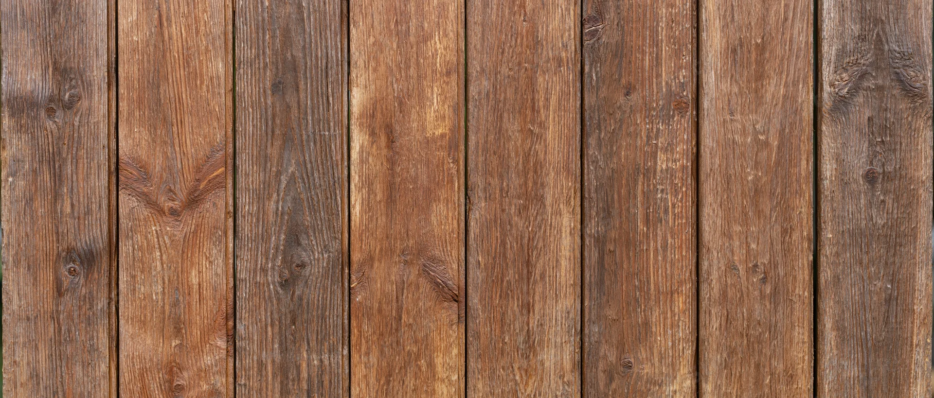 Vertical wooden planks forming a weathered rustic surface