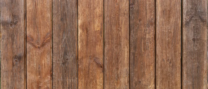 Vertical wooden planks forming a weathered rustic surface