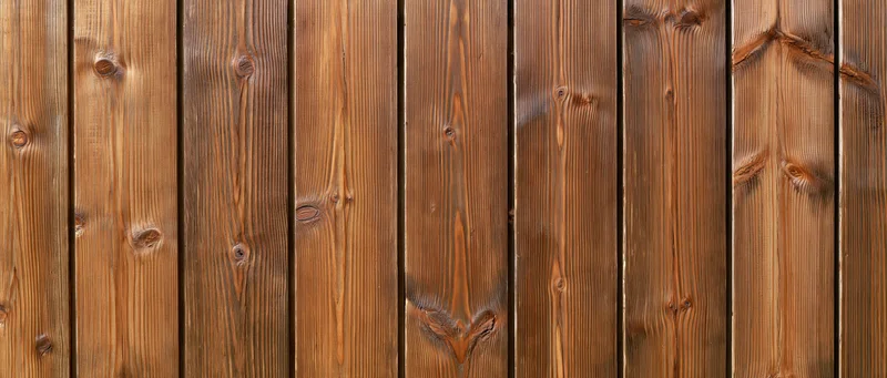 Vertical wooden planks forming a textured surface with visible grain and knots