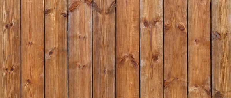 Vertical wooden planks forming a textured surface with natural grain and knots