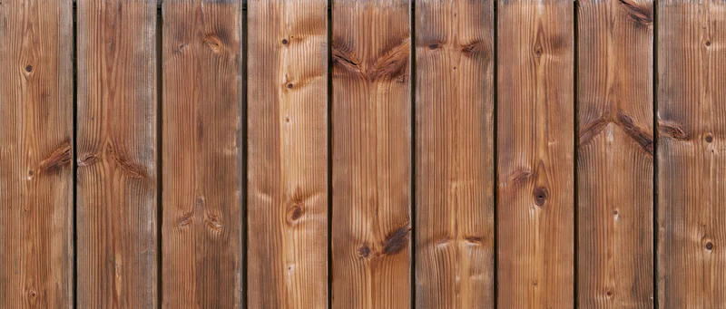 Vertical wooden planks forming a textured surface with visible grain and knots