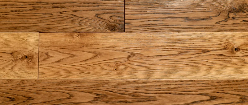 Close-up flat lay of wide-plank oak hardwood flooring filling the frame