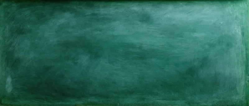 Close-up of a worn green chalkboard surface filling the frame with smudged texture and visible residue