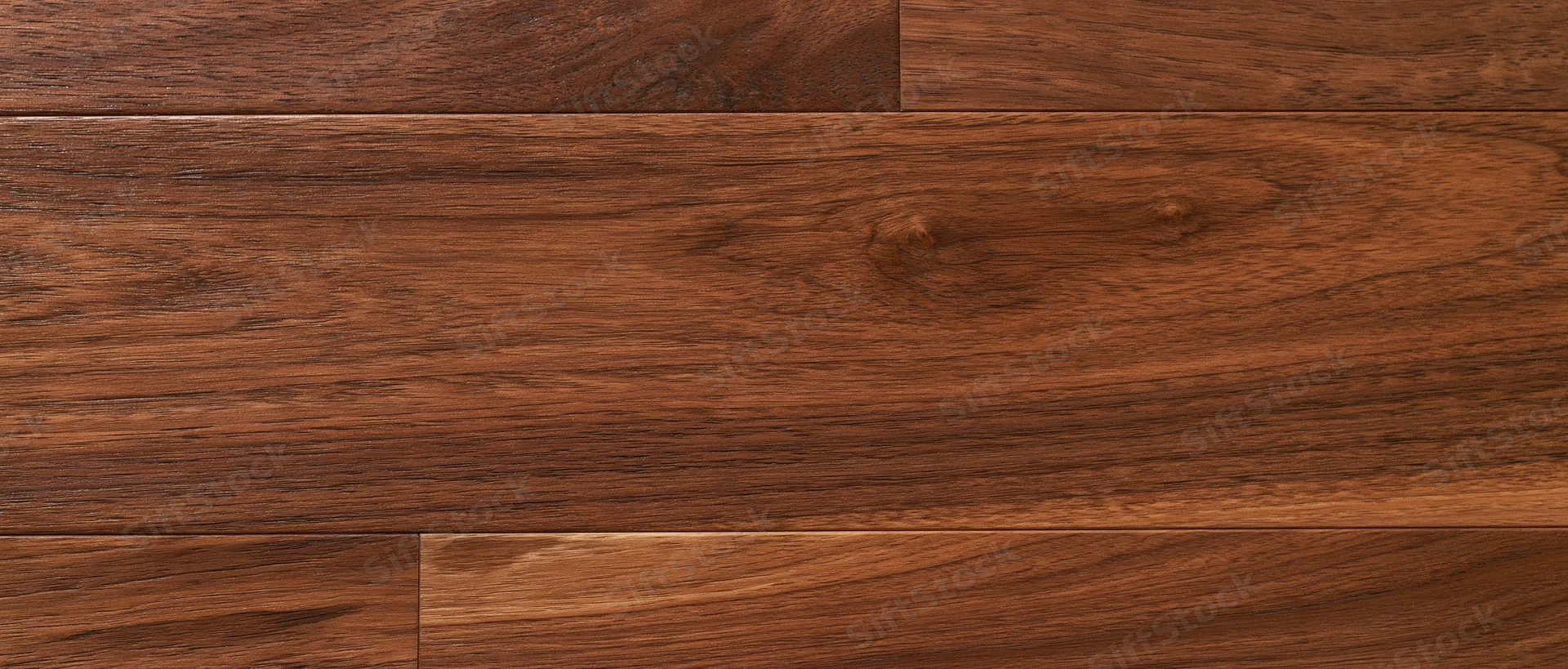 Close-up overhead view of dark walnut hardwood floor planks arranged in parallel rows