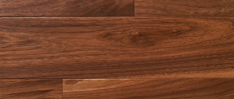 Close-up overhead view of dark walnut hardwood floor planks arranged in parallel rows