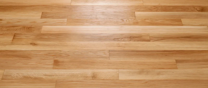 Close-up overhead view of light oak hardwood parquet flooring