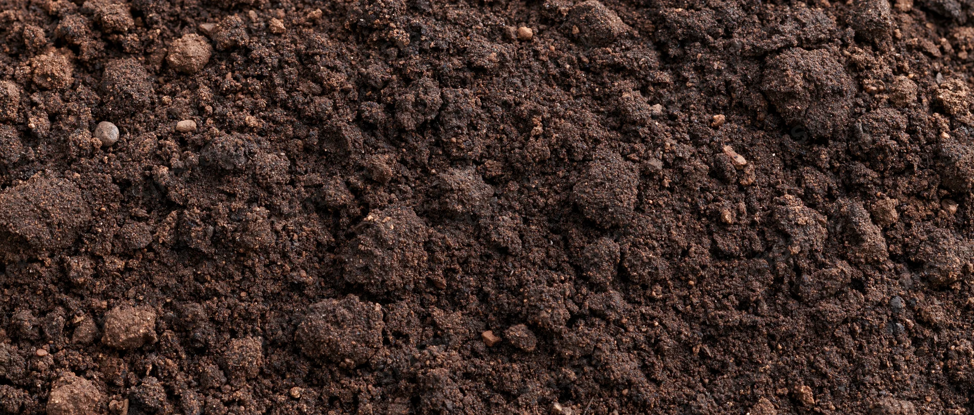 Close-up overhead view of tilled garden soil filling the frame