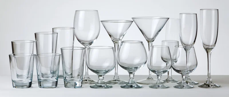 Empty glassware arranged in two rows on a white surface