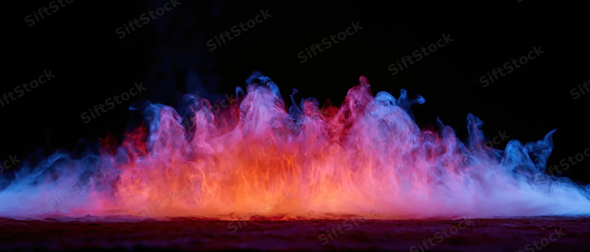 Colored smoke and flame-like tendrils rising from a flat surface against black background