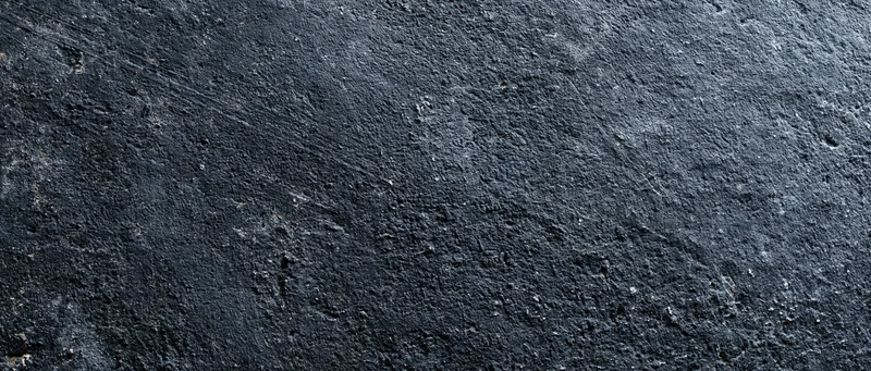 Dark weathered concrete wall surface filling the frame
