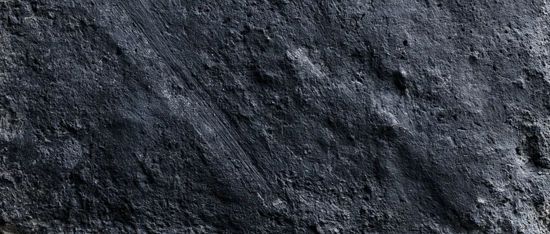 Dark weathered concrete wall surface filling the frame