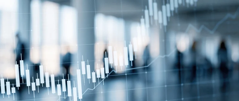 Financial candlestick chart showing upward trend overlaid on blurred office background