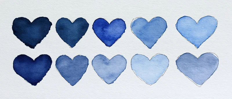 Ten hand-drawn blue watercolor hearts arranged in two rows on white textured paper