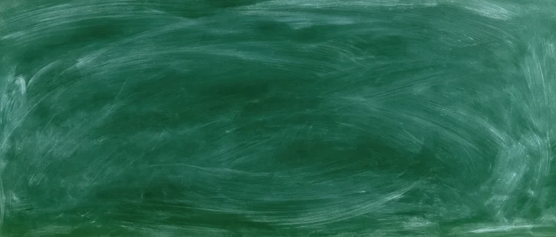 Wide panoramic view of an empty green chalkboard surface freshly erased with smudged white chalk marks