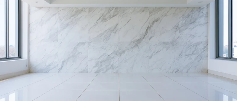 Empty modern room with white marble-veined wall and glossy tiled floor, natural light from windows