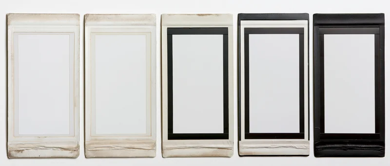 Five blank instant film photo frames arranged horizontally in a row