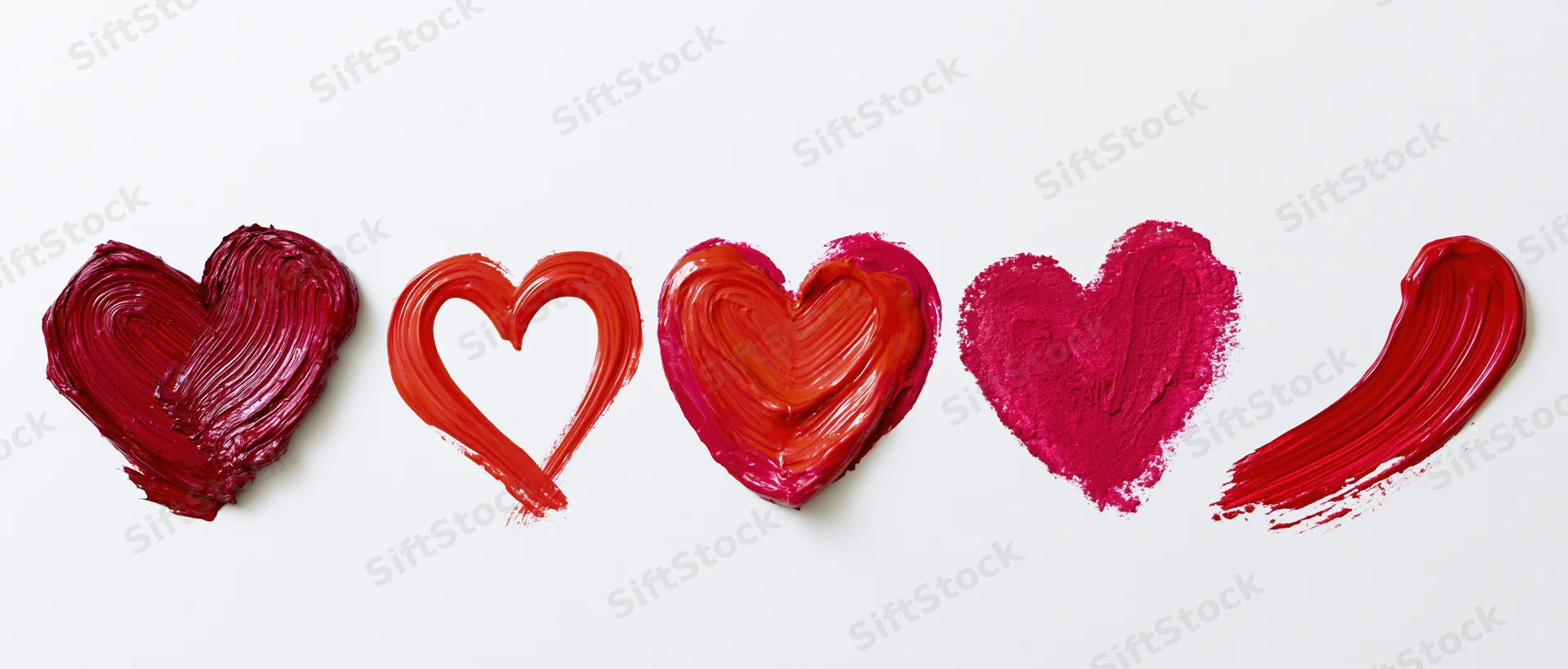 Five hand-painted red hearts in a horizontal row on white background
