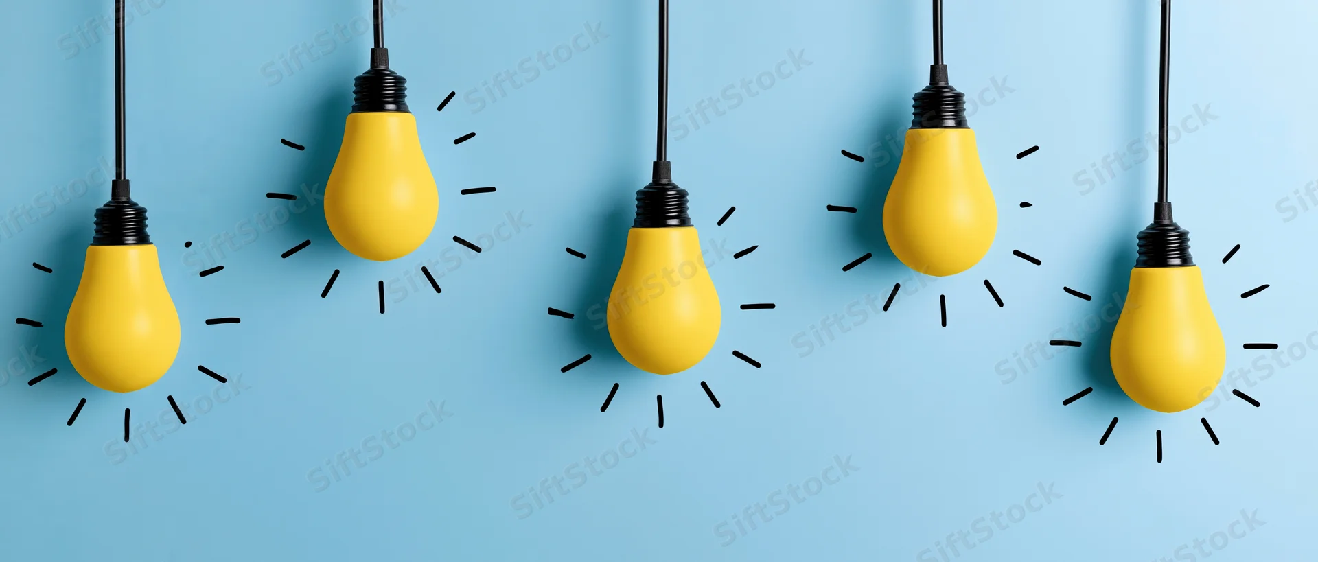 Five yellow matte light bulbs hanging from black cords against a blue background with radiating lines suggesting illumination