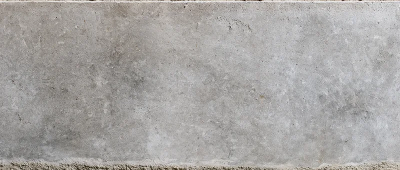 Wide flat concrete wall surface filling the frame