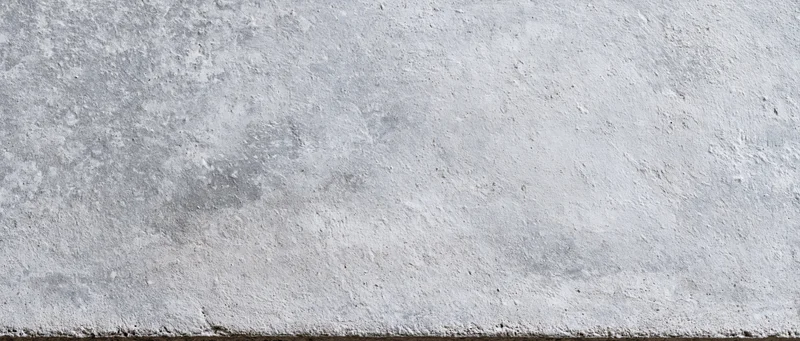 Close-up of a weathered concrete wall surface with rough texture