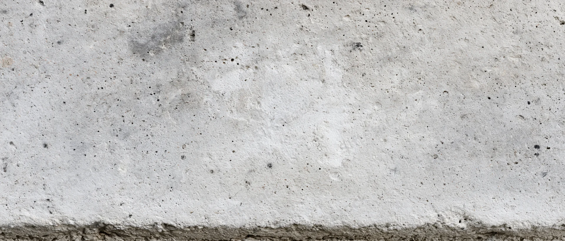 Wide view of a rough gray concrete wall surface filling the frame