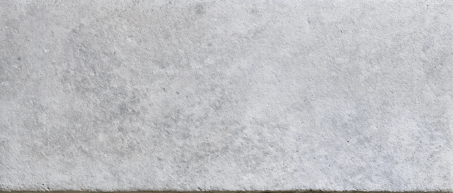 Close-up of a smooth concrete surface with subtle texture and gray tone
