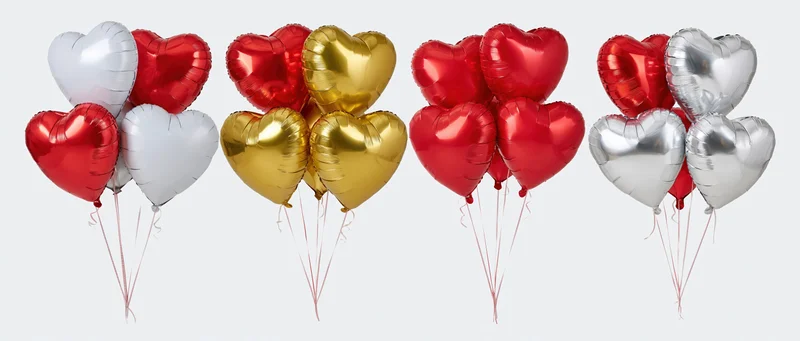 Four bunches of heart-shaped foil helium balloons arranged in a row against a white background