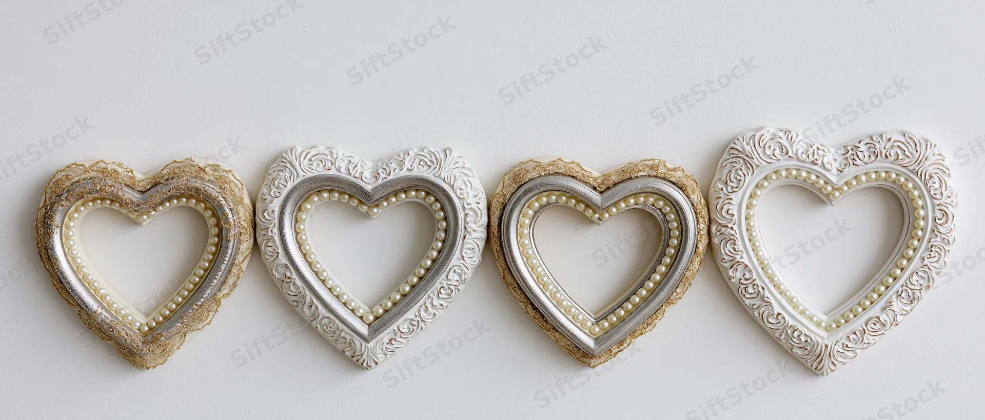 Four heart-shaped decorative frames arranged horizontally on a white surface
