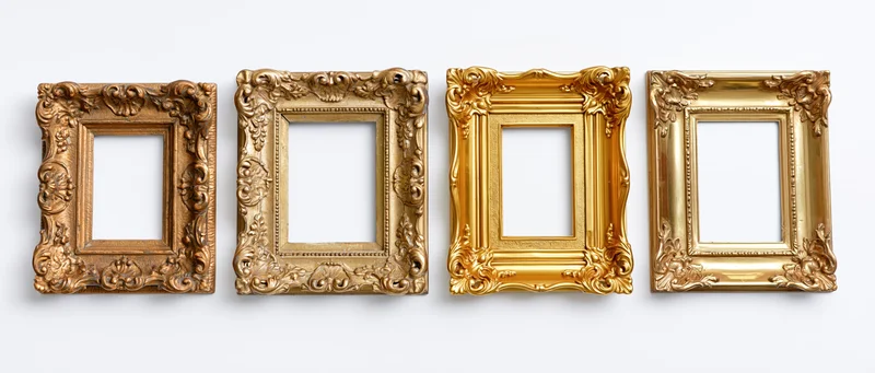 Four ornate gold picture frames arranged in a row on a white background