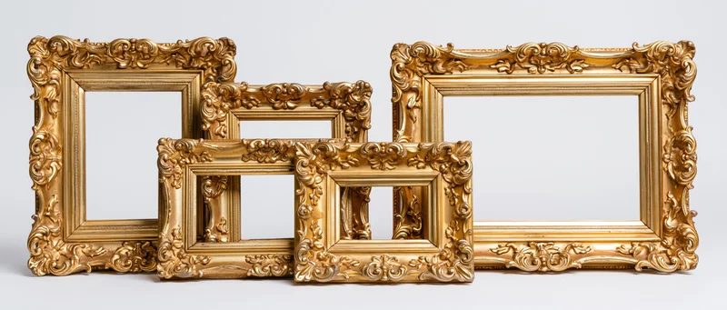 Ornate gold picture frames arranged in a row against a white background