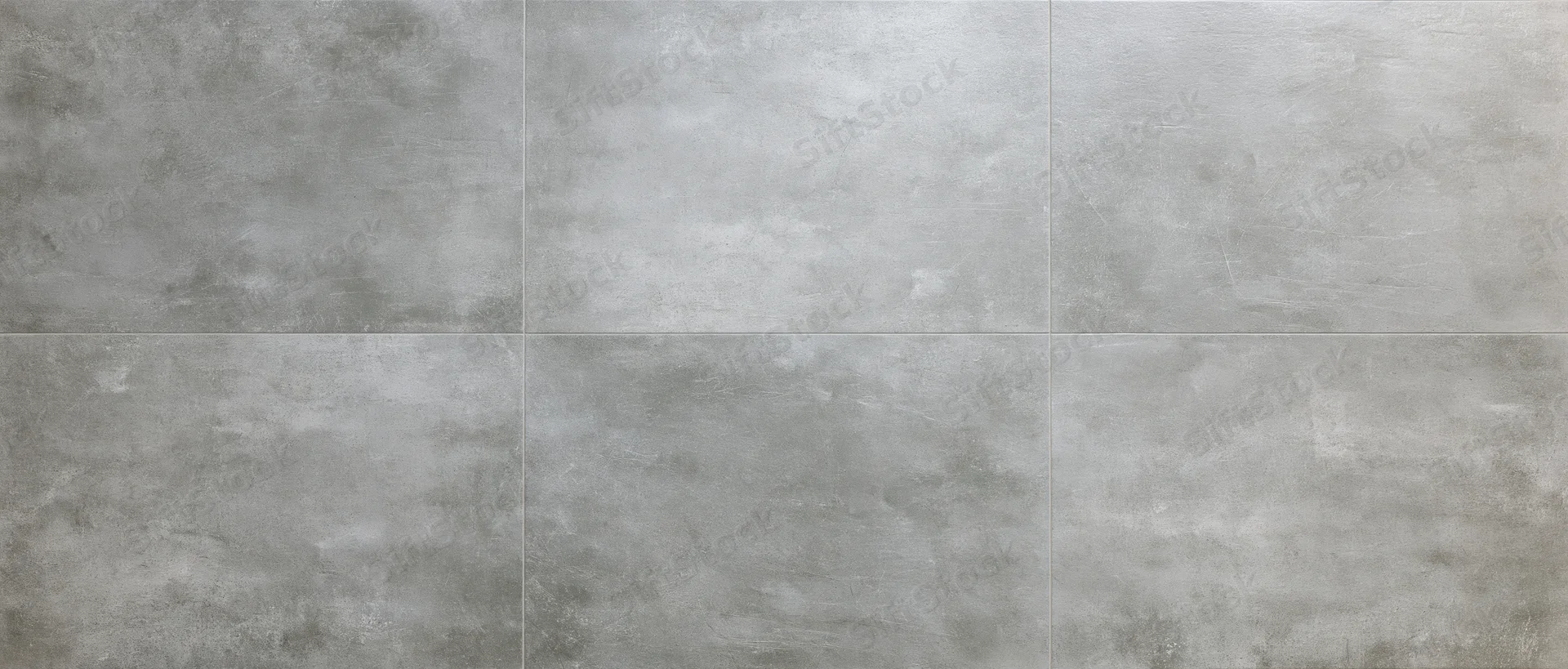 Large-format concrete floor tiles arranged in a grid pattern viewed from directly above