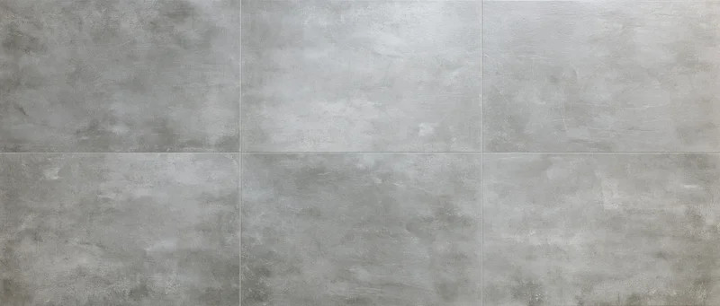 Large-format concrete floor tiles arranged in a grid pattern viewed from directly above