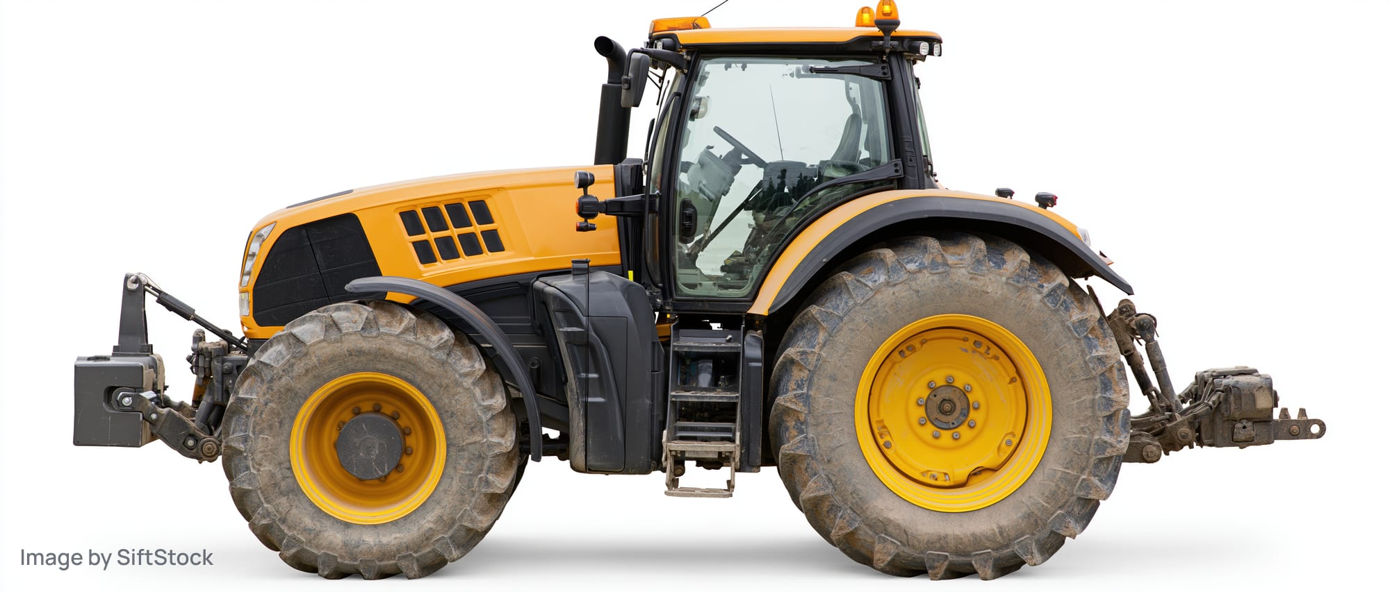 Large modern agricultural tractor in profile view isolated on white background