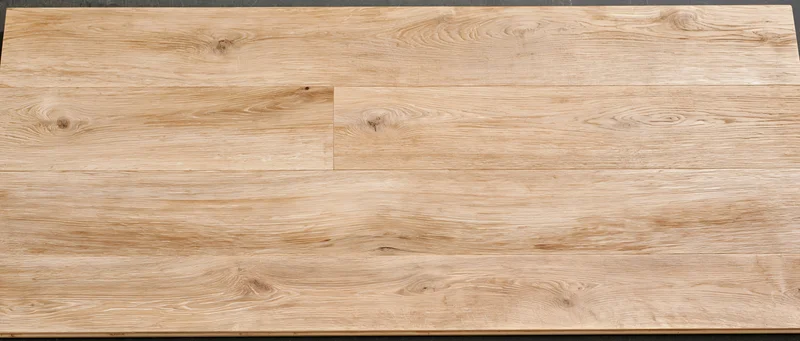 Light oak hardwood floor planks viewed from above showing natural wood grain and texture
