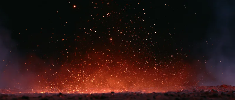 Fiery sparks rising from burning ground at night