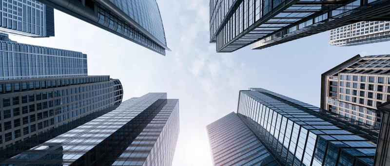 Low angle view of glass and steel corporate skyscrapers in a city skyline
